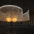 Elegant Modern Hall Featuring Large Chandelier With Transparent Pendants And Smooth Floor Reflections