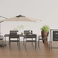 Beige Outdoor Umbrella Over Black Dining Set With Green Plant Chalkboard Sign On Wooden Floor