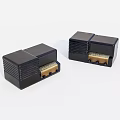 Two Black Electronic Devices With Square Design And Golden Connectors