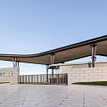 Modern Entrance Gate With Curved Canopy Metal Columns Grass And Paved Area