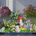 Garden Ornamental Arrangement With Colorful Flower Shrubs Rabbit Statues And Green Plants