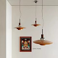 Modern Amber Pendant Lights With Wooden Metal Design Above Framed Artwork On White Wall