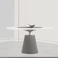 Round Marble Top Dining Table With Black Conical Base Gold Accent And Decorative Bird Ornament