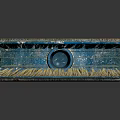 Vintage Paintbrush With Blue Handle And Brown Bristles On Reflective Surface