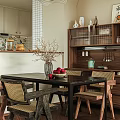 Elegant Modern Dining Room With Wooden Table Wicker Chairs Dried Branch Vase And Fruit Bowl