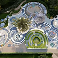 Interactive Children's Play Area With Circular Maze Elephant Figures And Green Spaces