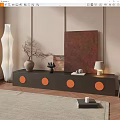 Dark Wood TV Stand With Orange Circular Accents And Vase Lamp Artwork Against Beige Wall
