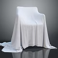 White Textured Cloth Covered Chair With Draped Fabric On Dark Surface