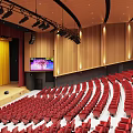 Banquet Hall Interior With Red Seats Stepped Rows Wooden Stage And Lighting Fixtures