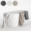Elegant Modern White Bathtub With White Gray And Beige Towels Hanging