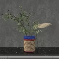 Woven Vase with Blue Red Beige Stripes Holding Green Leaves Pampas Grass on Gray Background