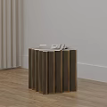 Modern Golden Side Table With Vertical Slats And Stack Of Books On Wooden Floor
