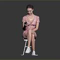 Woman Sitting On Chair In Floral Dress Using Smartphone With White Sneakers And Gray Background