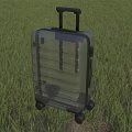 Green Hard Shell Suitcase With Black Telescopic Handle And Rolling Wheels On Grass Field