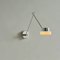 Modern Chrome Wall Lamp With Adjustable Arm And Glass Shade Emitting Warm Light