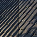 Dark Roof Tiles Neatly Arranged On Modern Roofing Structure