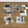Open Interior Design Magazines With Home Photos Scattered On Wooden Floor