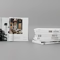 Open Book Displaying Home Interior Design Pages With Stack Of Magazines