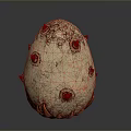 Artistic Egg Shaped Sculpture Carving with Red Spots Spikes and Textured Surface