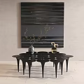 Modern Black Coffee Table With Geometric Legs And Decorative Items Against Abstract Wall Art