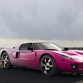 Pink Sports Car Parked By Seaside With Ocean View And Cloudy Sky