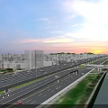 Modern Bridge with Multi Level Roads Urban Buildings Green Spaces and Sunset Sky