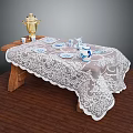 Wooden Coffee Table With White Lace Tablecloth And Gold Teapot Blue Teacups Plates