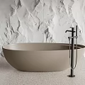 Modern Freestanding Neutral Beige Bathtub With Black Faucet And White Textured Stone Wall
