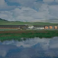 Modern Visitor Center with Lake Reflection and Scenic Grassland Near Hills Under Cloudy Sky