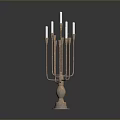 Brass Candelabra With Multiple Arms And White Candles On Black Surface