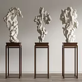 Three White Stone Sculptures On Dark Wooden Stands For Interior Display Decoration