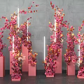 Elegant Floral Installation With Pink Orange Flowers On Columns White Strip Lights And Gray Wall