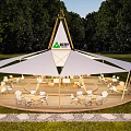 Large White Camel Brand Outdoor Tent With Wooden Frame Green Trees And Chairs