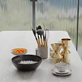 Modern Kitchen Countertop With Black Salt Bowl Wooden Handle Utensils And Golden Measuring Cups
