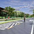 Municipal Road Design Featuring Green Landscaping Bicycle Lane Pedestrian Path Trees Cyclists And Pedestrians