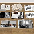 Open Books and Magazines with Black and White Photos and Interior Images on Wooden Floor