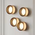 Four Round Illuminated Wall Lights With Modern Design On White Wall 3d model