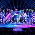 Energetic Concert Stage Performance With Colorful Lighting And Live Music Artist