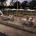 Scenic Campsite With Teepee Tents Outdoor Tables Chairs And String Lights On Wooden Deck