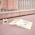 White Baby Crib With Diamond Tufted Headboard Pastel Pink Quilted Blanket And Cozy Nursery Setting