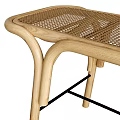 Light Wooden Footstool With Curved Frame Wicker Top And Draped Plaid Blanket