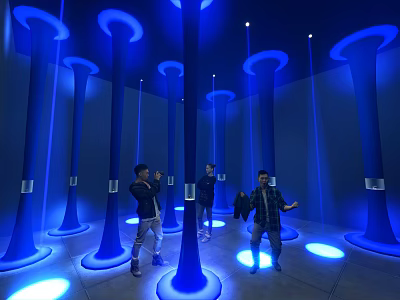 Interactive Exhibition Hall With Blue Glowing Columns And Visitors Experiencing Lighting Effects 3d model