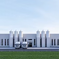 Industrial Factory Building With White Exterior Spire Topped Towers Trucks And Green Lawn