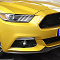 Yellow Ford Mustang Sports Car Parked In Modern Indoor Garage With Tire Tracks
