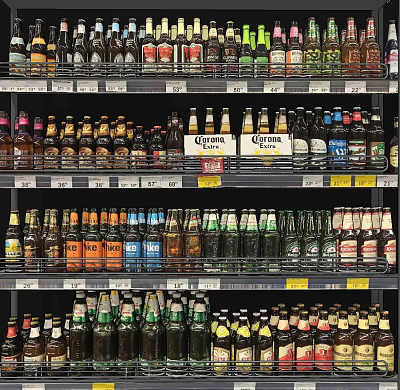 Various Alcohol Bottles and Drinking Glasses on Supermarket Shelves Display with Colorful Labels 3d model