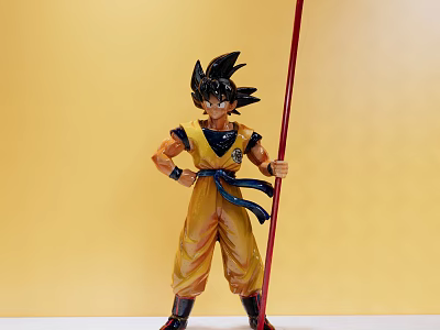 Dragon Ball Anime Character Doll With Yellow Outfit Red Staff And Black Spiky Hair 3d model