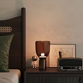 Warm Light Table Lamp On Bedroom Bedside Table With Astronaut Figurine Radio And Picture Frame