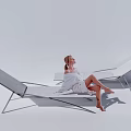 Modern Design Lounge Chair with Metal Frame Light-colored Cushion and Woman Sitting in White Background