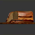 Fresh Brown Bread On Wooden Round Cutting Board With Whole Loaf And Sliced Pieces
