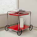 Red Two Tier Serving Cart With Metal Frame Black Wheels Newspaper And White Jug